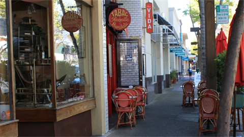Downtown street with outdoor restaurant seating 
